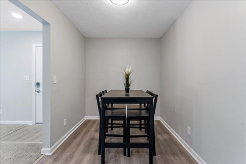 an empty dining room with a table and chairs