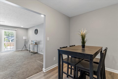 a dining room with a table and chairs and a window