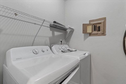 a white washer and dryer in a white laundry room with a dryer