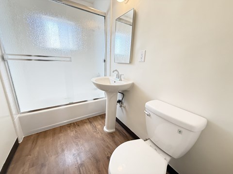A white toilet sits next to a sink in a bathroom.