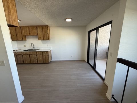 A kitchen with wooden cabinets and a white countertop.