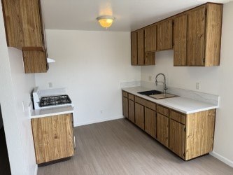 A kitchen with wooden cabinets and a white countertop.