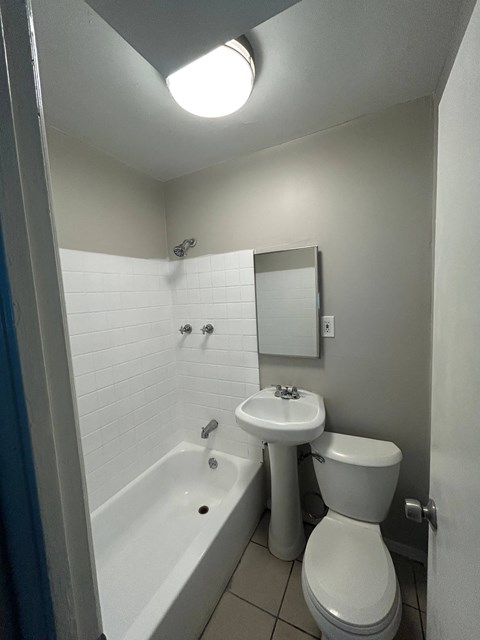 a bathroom with a toilet and a sink and a tub