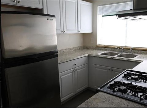 a kitchen with a stove and a refrigerator