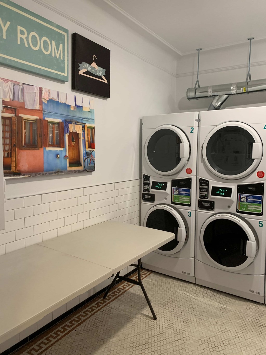 a washer and dryer in a laundry room with a table