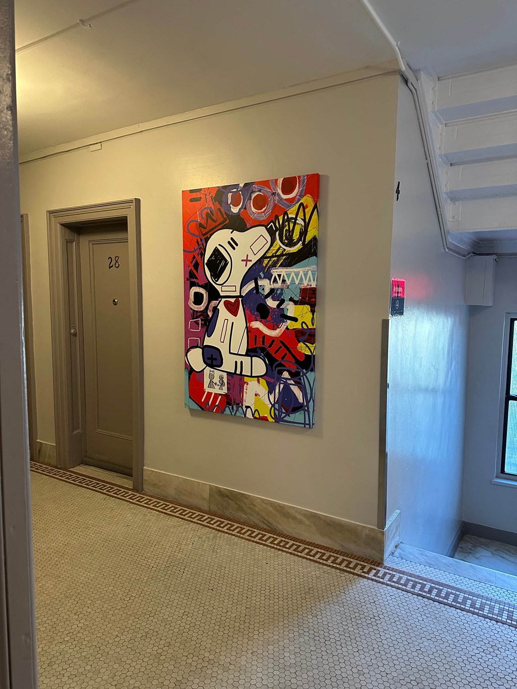 a painting of a dog on a wall in a hallway