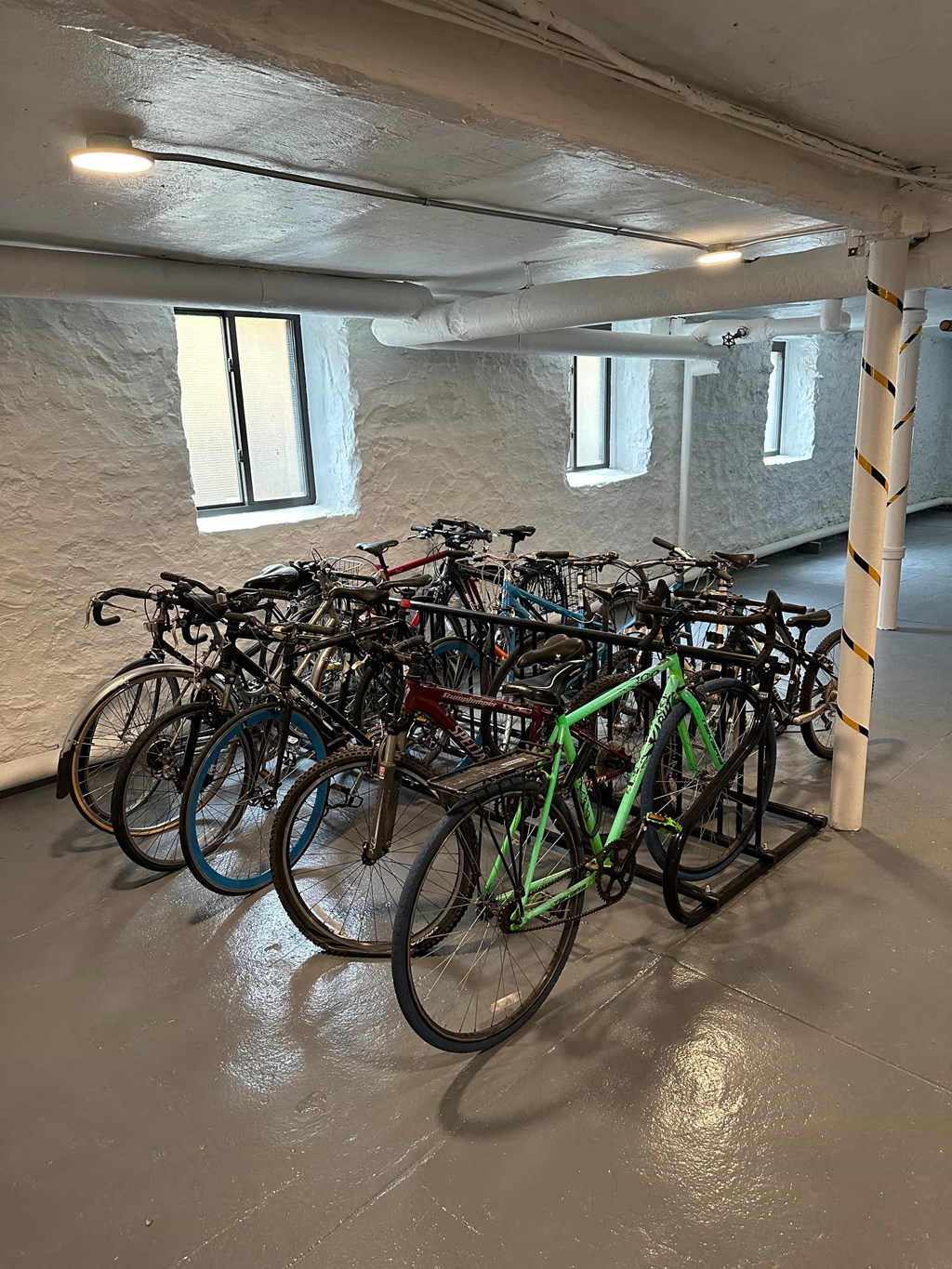 a bunch of bikes parked in a parking garage