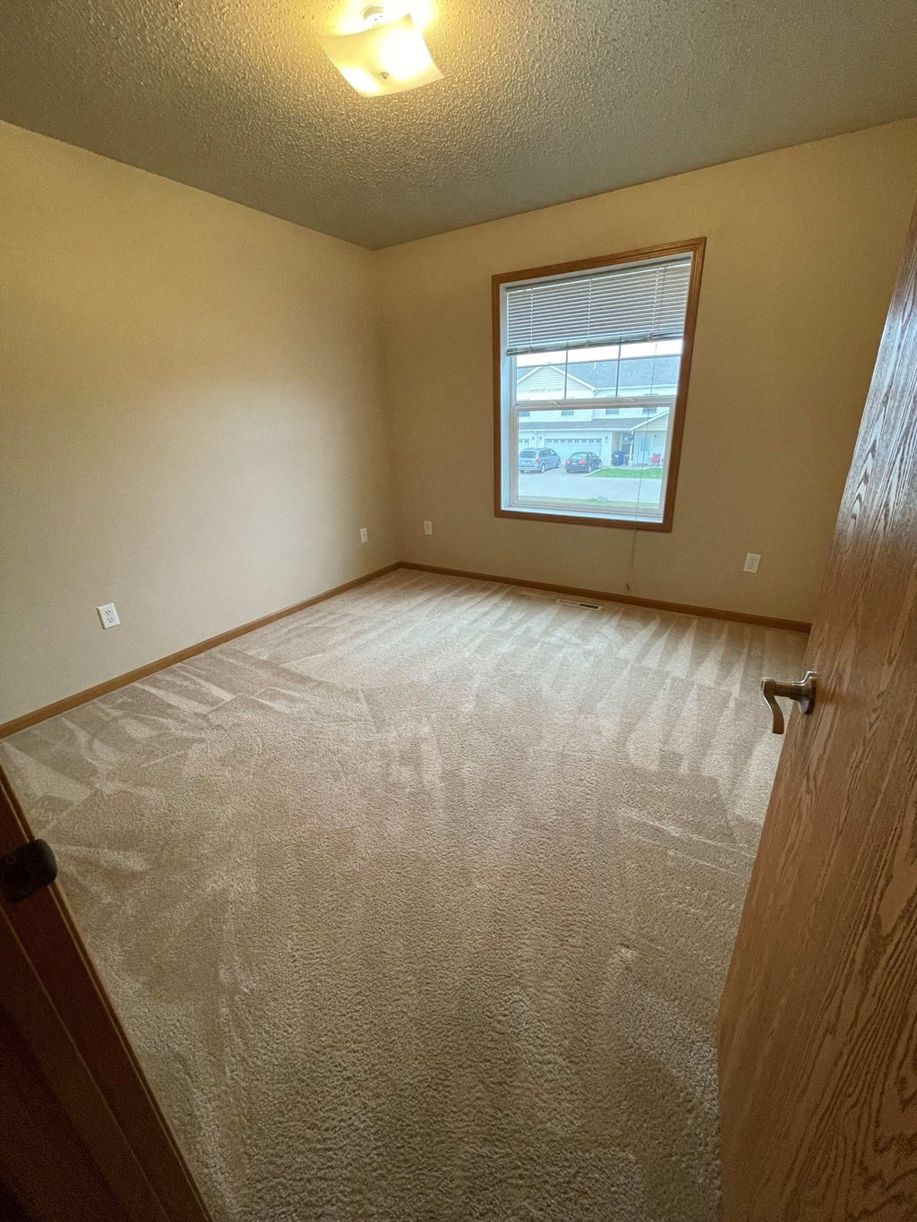 the living room of an empty house with a window