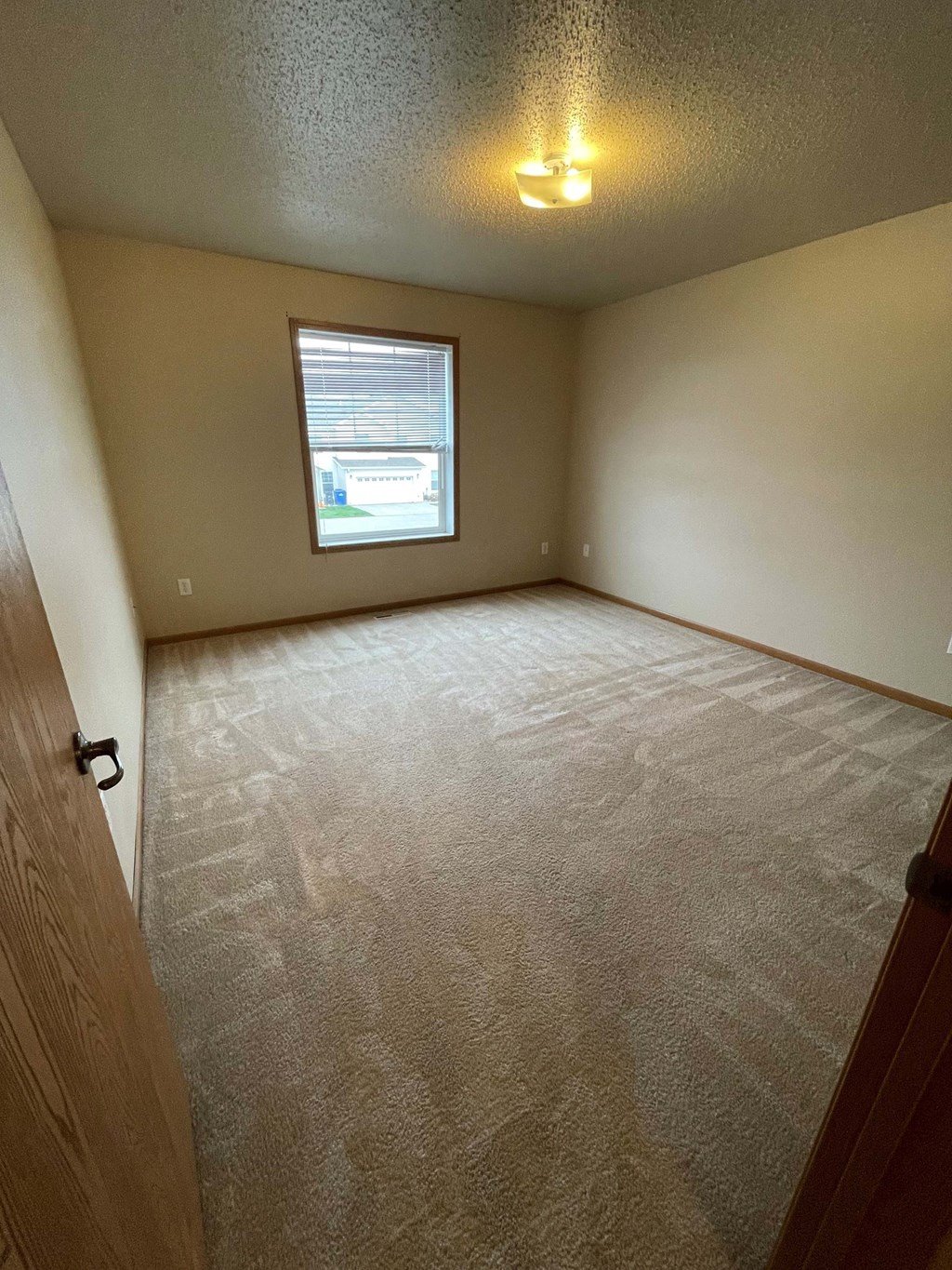 the living room of an empty house with a window
