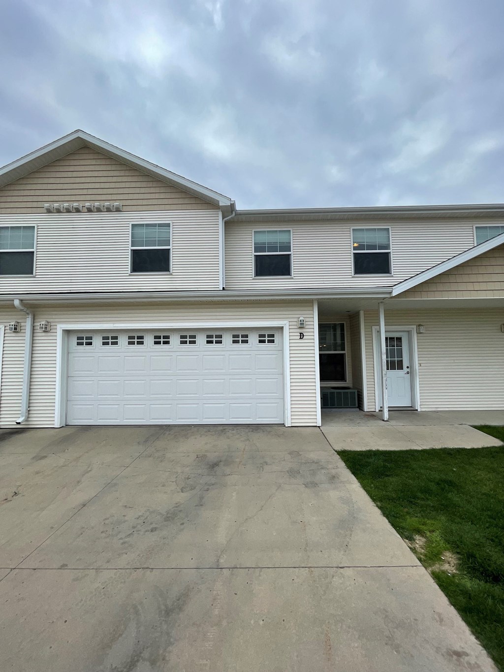 a white house with a driveway and a garage door