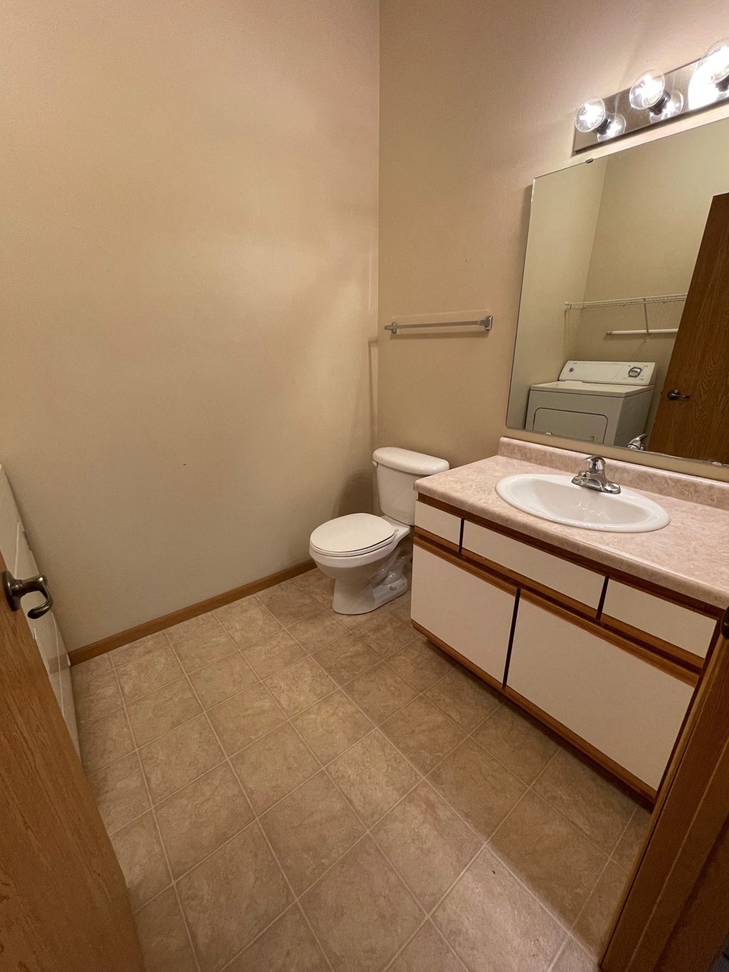 a bathroom with a toilet and a sink and a mirror