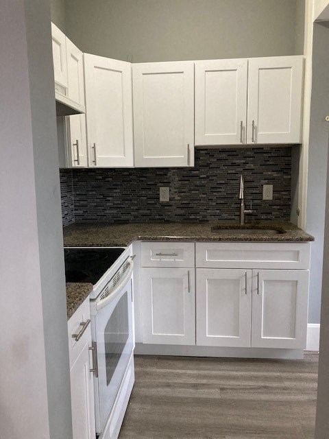 a white kitchen with white cabinets and a sink