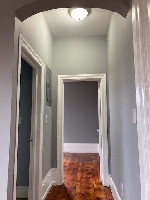 a hallway with two doors and a wood floor