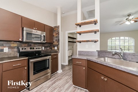 a kitchen with stainless steel appliances and wooden cabinets