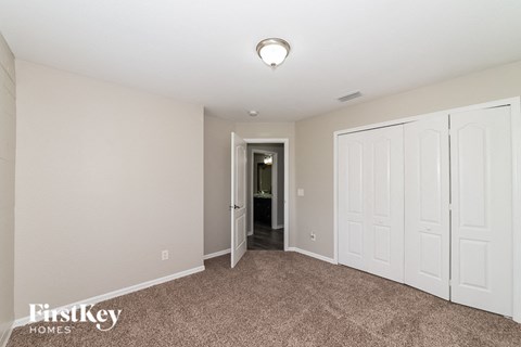 a bedroom with two closets and a door to a hallway