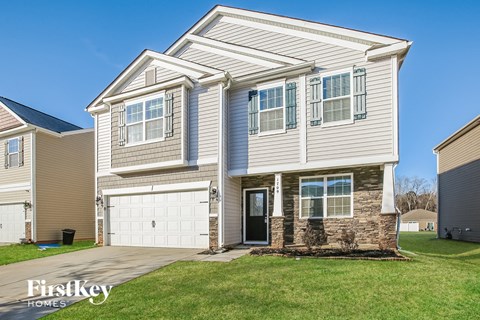 A two-story house with a garage is for sale by FirstKey Homes.