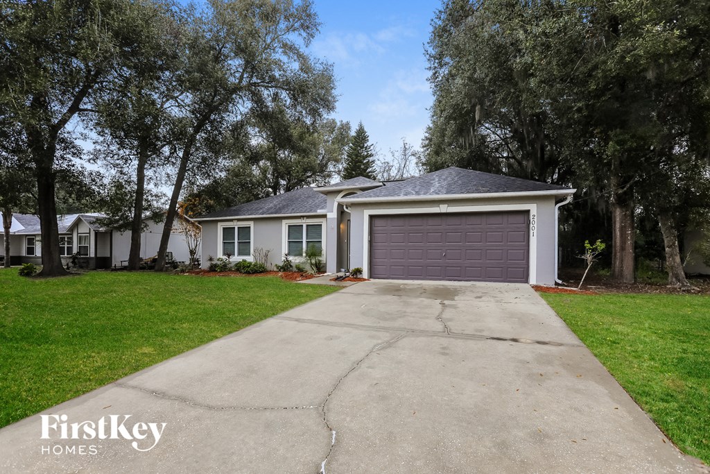 a white house with a purple garage door