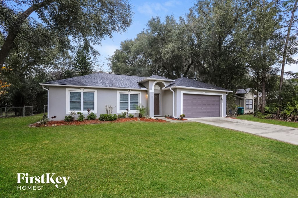 a home with a lawn and a driveway