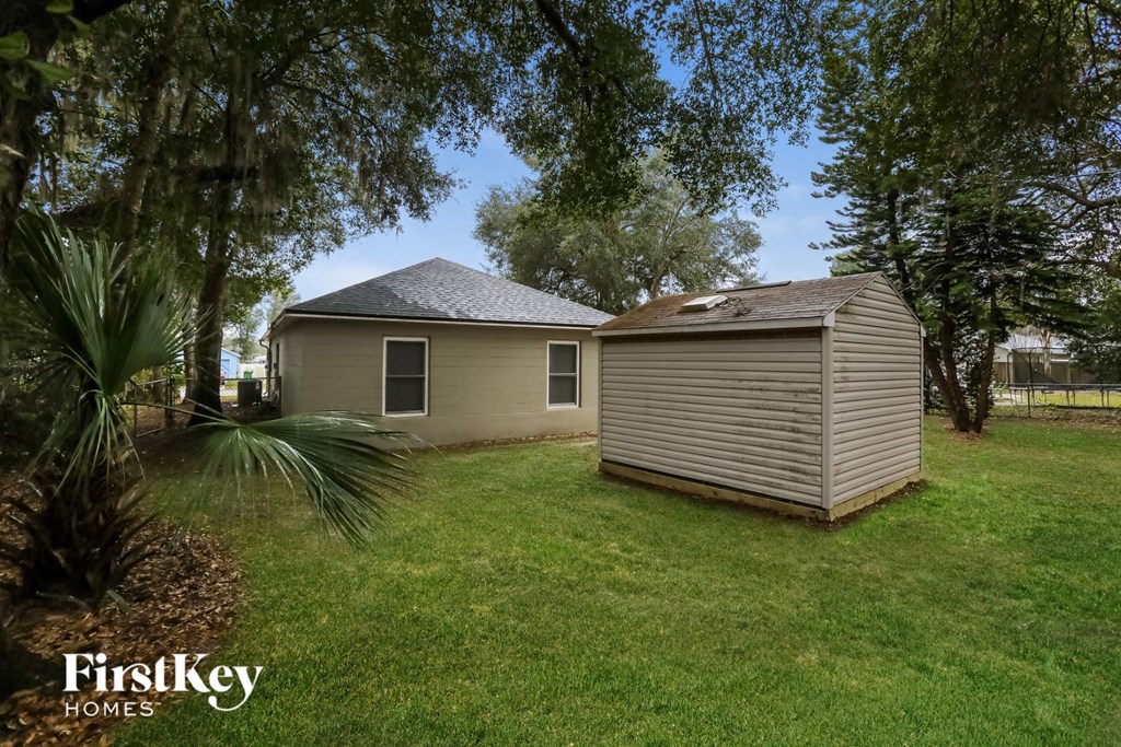 a backyard with a shed and a house
