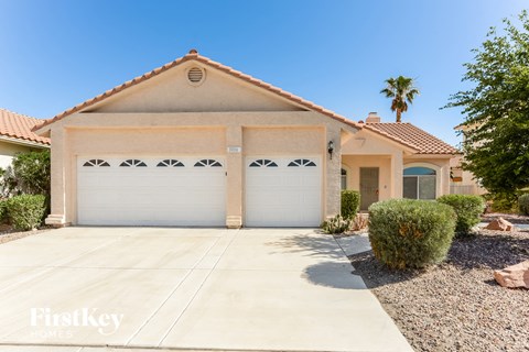 a home with two garage doors and a driveway