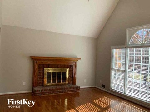 a living room with a fireplace and a large window