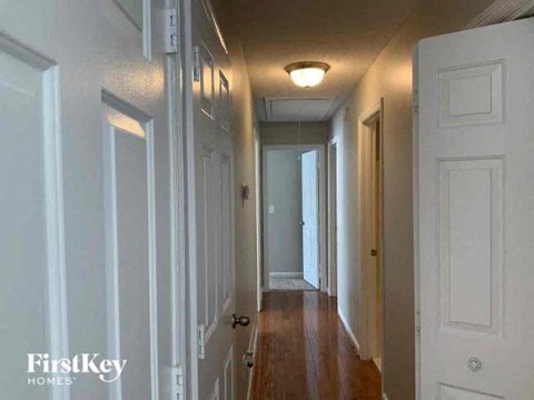 a hallway with white doors and a light on the ceiling