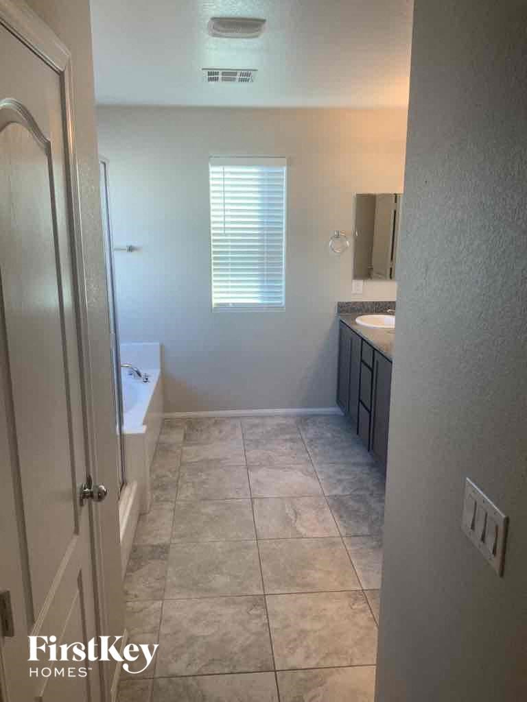 a bathroom with a shower and a sink and a bath tub