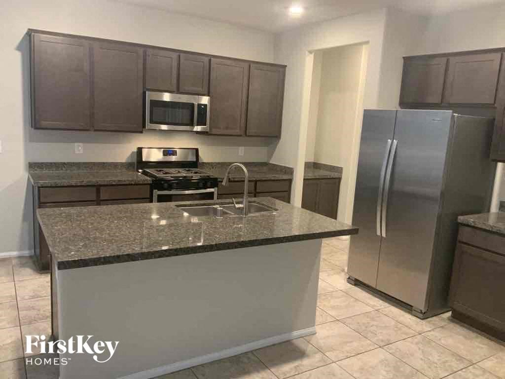a kitchen with stainless steel appliances and granite counter tops