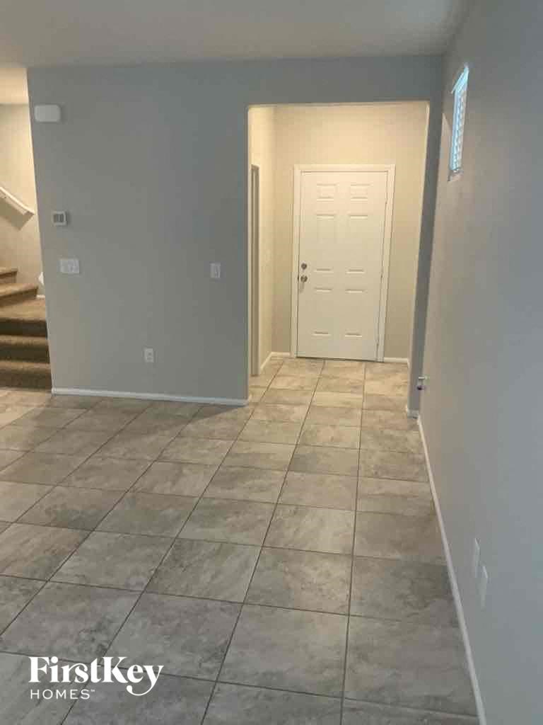 a tile floor in a hallway with a white door