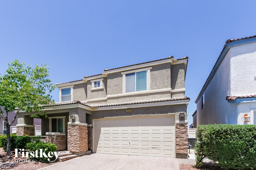 a house with a white garage door in front of it