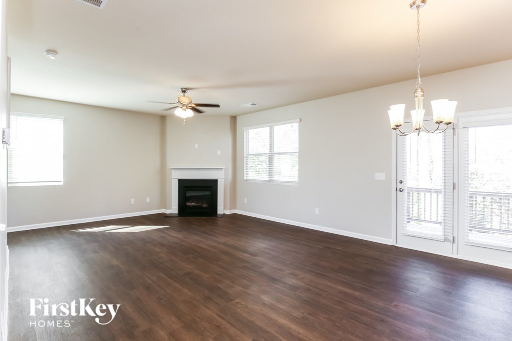 a living room with a fireplace and a ceiling fan
