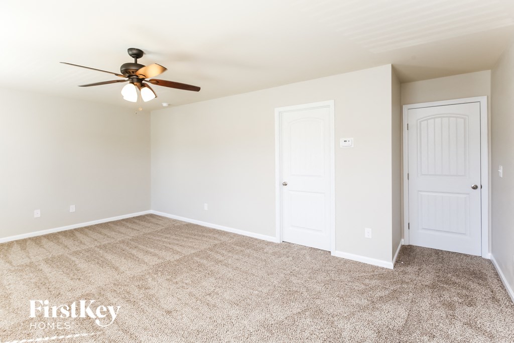 a bedroom with a ceiling fan and a closet