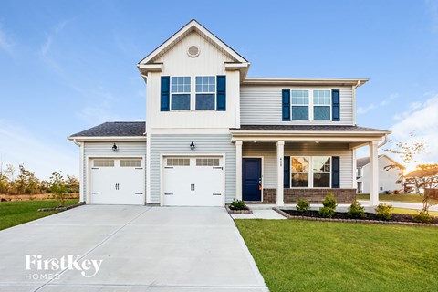 a white house with blue shutters and white doors