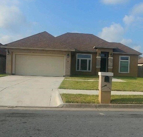 a house with a driveway and a parking meter
