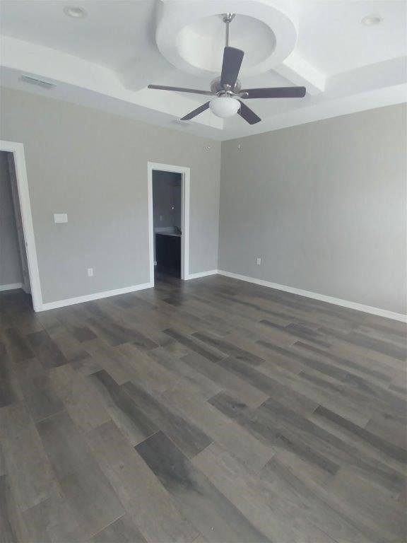 a living room with wood floors and a ceiling fan