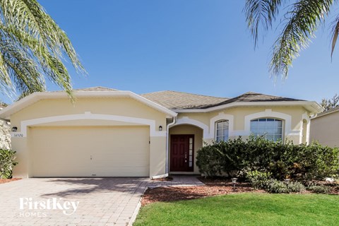 a house with a lawn and palm tree