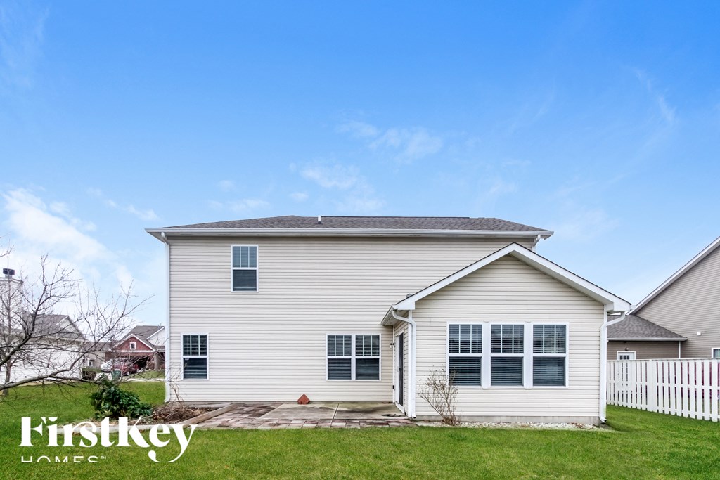A house with a white picket fence in front of it.