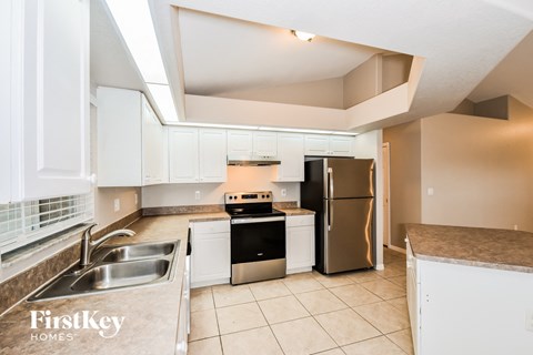 a kitchen with stainless steel appliances and white cabinets