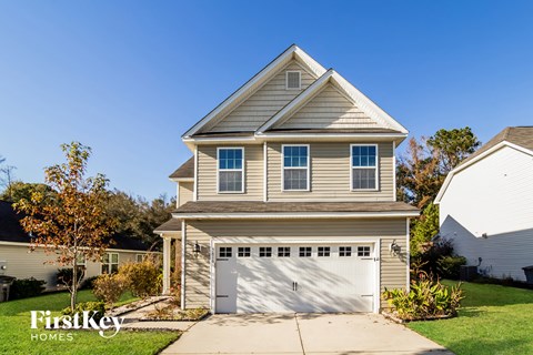 a tan house with a white garage door