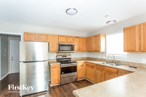 a kitchen with wooden cabinets and stainless steel appliances