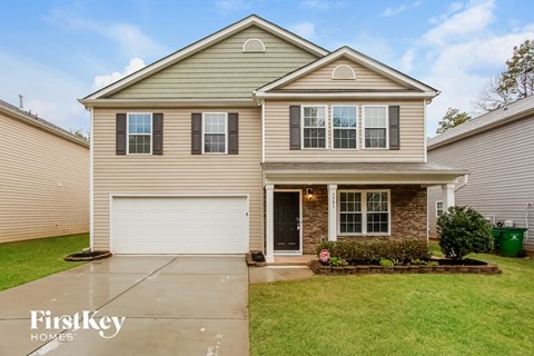a beige house with a white garage door
