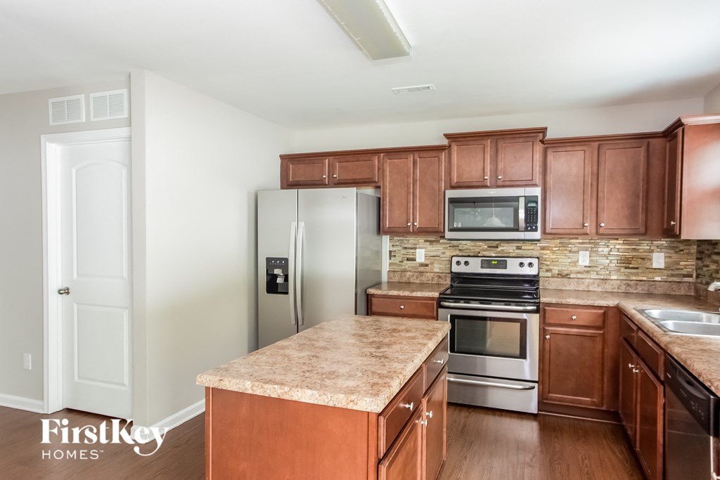 a kitchen with wooden cabinets and stainless steel appliances