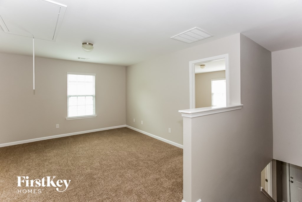a bedroom with a carpeted floor and a window