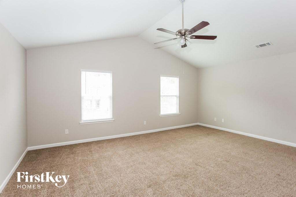 a bedroom with carpet and a ceiling fan