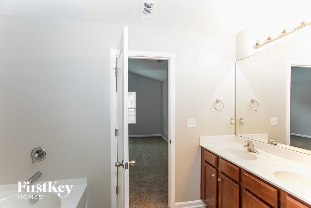 a bathroom with two sinks and a large mirror