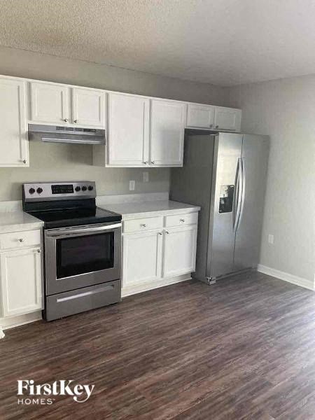 a kitchen with stainless steel appliances and white cabinets