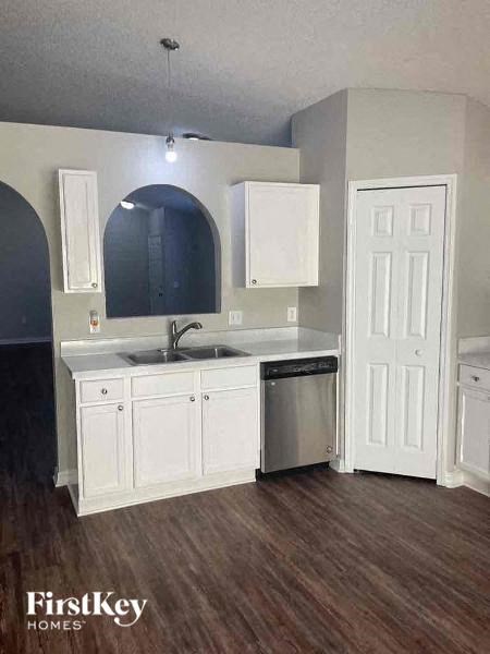 a kitchen with white cabinets and a sink