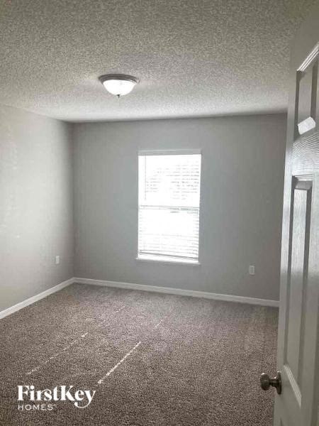 an empty room with a window and a door