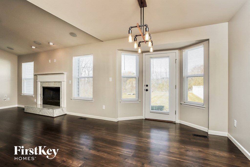the living room of an empty house with a fireplace