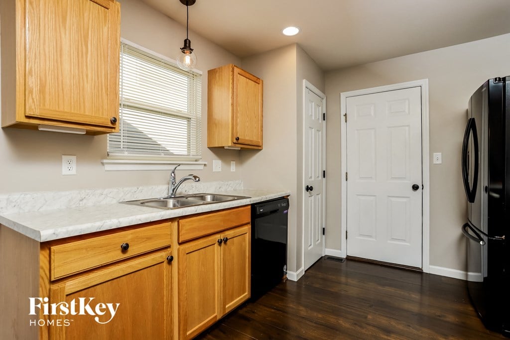 a kitchen with a sink and a refrigerator and a door